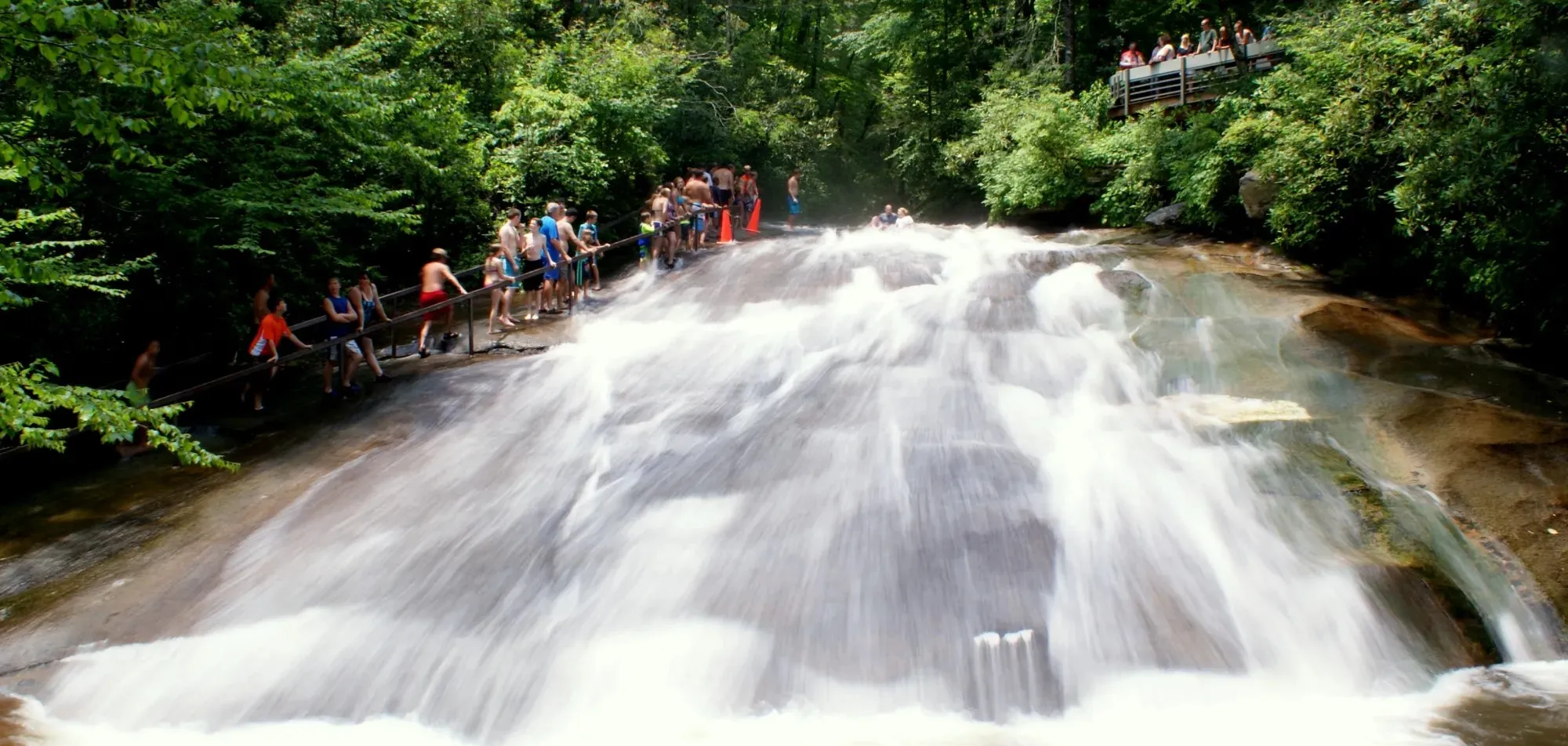 A slider riding the 60-foot granite water slide at Sliding Rock into the pool below in Pisgah National Forest